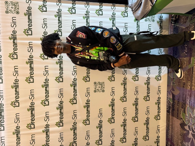 Guest in front of Dreamlife-Sim™ step-and-repeat at an event